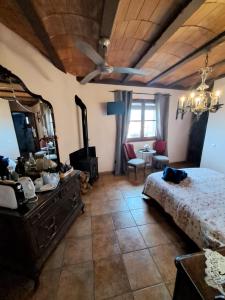 a bedroom with a bed and a wooden ceiling at Ca la Serreta in Cretas
