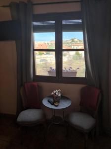 a room with two chairs and a table and a window at Ca la Serreta in Cretas