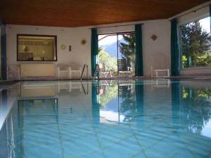 ein Pool mit blauem Wasser in einem Haus in der Unterkunft Appartements Amrusch in Sankt Jakob im Rosental