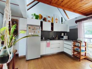 a kitchen with white cabinets and a refrigerator at Mermaid Cove in Blue Bay