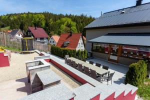 a group of benches and a building with a playground at Ferienhaus 'am Berg' in Fehrenbach