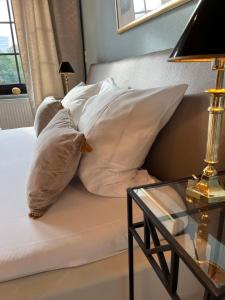 um homem deitado numa cama com almofadas em Appartementhaus Herrenhäuser Gärten em Hanôver