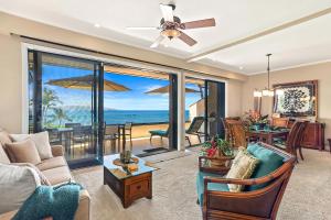 a living room with a view of the ocean at Makena Surf G-201 - End Unit, Panoramic Views, AC! in Wailea