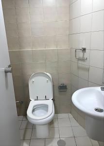 a bathroom with a toilet and a sink at Heart of Abu Dhabi - Nice Affordable Master Room in Abu Dhabi