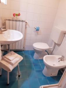 a bathroom with a toilet and a sink at Borgo Sicelle Residence in San Donato in Poggio