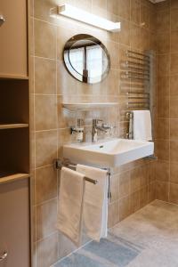 a bathroom with a sink and a mirror at Apartment Dietrich Sylvia in Mellau