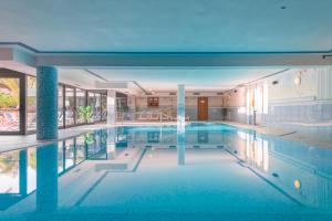 a large swimming pool in a building at Hotel Garda Bellevue in Limone sul Garda