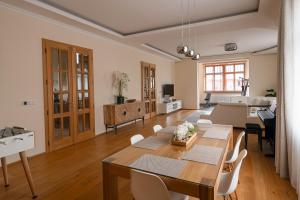 a living room with a table and a dining room at Executive 2-Bdrm central suite in Ústí nad Labem