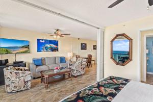 a living room with a couch and a table at Mana Kai 410 - Ocean front at Keawakapu Beach, AC in Wailea