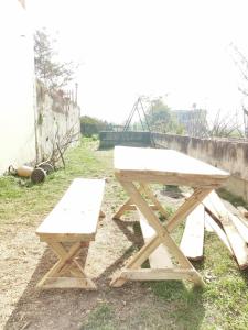 a picnic table and a bench in a field at Indrayanifarms in Sundarijal