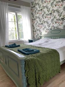 Un dormitorio con una cama con toallas azules. en Satavuotias helmi Mäntässä, en Mänttä