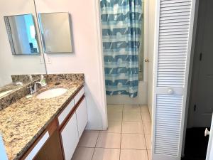 a bathroom with a sink and a mirror at Brittany - Perfect 3 BR Pool Home in Kissimmee