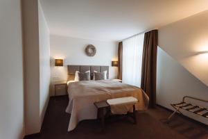 a hotel room with a bed and a window at Landhotel Potsdam in Potsdam