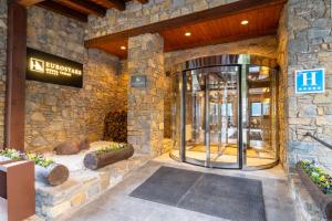 a lobby with a revolving door in a building at Eurostars Royal Tanau in Baqueira-Beret