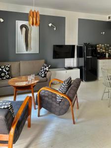 a living room with a couch and a table at Apartament Relax Neptun Park in Gdańsk