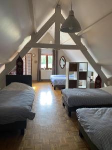 a room with three beds in a room at Hof van Kalenberg in Borgloon