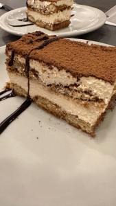 a piece of cake on a white plate on a table at Hotel 376 in Villa Carlos Paz