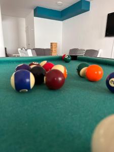 a group of billiard balls on a pool table at Hotel 376 in Villa Carlos Paz