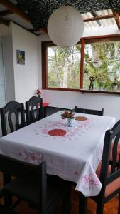 a table with a white table cloth and flowers on it at Casa Luka in Turrialba