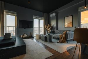 a living room with a couch and a table at ETERN Apart Hotel in Prishtinë