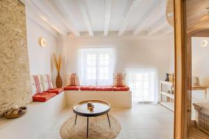 a living room with a couch and a table at Single House with Jacuzzi and Sauna in Normandy in Ranville