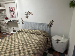 a bedroom with a bed with a plaid bedspread at K.room2 