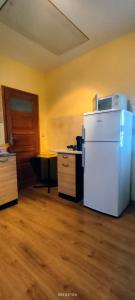 a kitchen with a white refrigerator in a room at Pokoje na Widokowej 33 in Korbielów