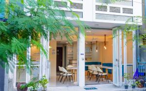 a patio with chairs and a table in a building at Moodhukoe in Hulhumale