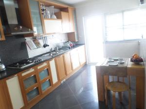 a kitchen with wooden cabinets and a counter top at 33 José Farinha in Lisbon