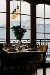 a dining room table with a view of mountains at White Sheep by LoftAffair in Kościelisko
