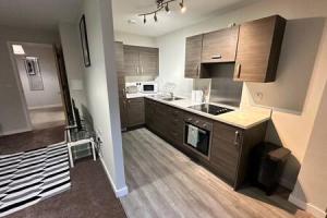 a kitchen with a sink and a counter top at Cosy 1 Bed Central Manchester Apartment Sleeps 2 in Manchester