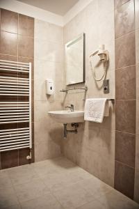 a bathroom with a sink and a mirror at Hotel Vír in Vír