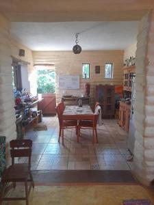a kitchen with a table and chairs in a room at Casona de Barro in Imbassai