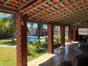 a brick patio with a pergola and a pool at Espaço Billynghan in Barreirinhas +50 photos