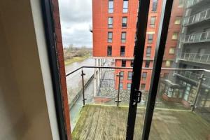 a view of a balcony from a window of a building at Fab 1 Bed Apartment with Balcony and River Views Sleeps 2 in Manchester