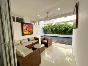 ein Wohnzimmer mit einem Sofa und einem Tisch in der Unterkunft Casa Encanto Del Mar in Cartagena de Indias