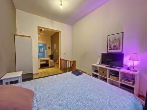 um quarto com uma cama e uma televisão numa mesa em Cosy Apartment Brussels - Flagey em Bruxelas