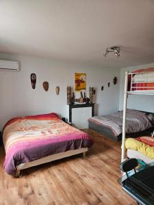 1 dormitorio con 2 literas y suelo de madera en LA MEUTE, en Mars-sur-Allier