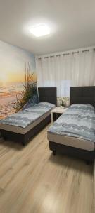 two beds sitting in a room with the beach at Costa del Hel in Hel