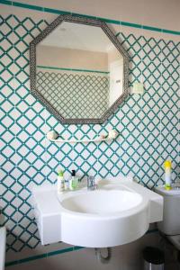 a bathroom with a white sink and a mirror at Appartement avec vue sur mer in Gammarth