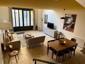 a living room with a table and a dining room at Hôtel Villa Blomet in Paris