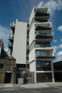 a tall building with balconies on the side of it at Designer Room with Private Bathroom in London