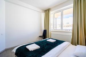 a bedroom with a bed and a large window at 2-room Apartment Gudauri Penta 703 in Gudauri