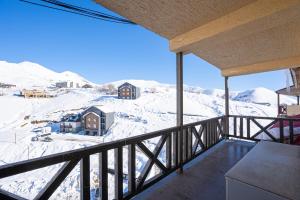 a balcony with a view of a snow covered mountain at 2-room Apartment Gudauri Penta 703 in Gudauri