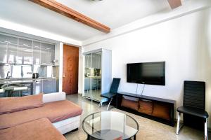 a living room with a couch and a tv at 2-room Apartment Gudauri Penta 703 in Gudauri