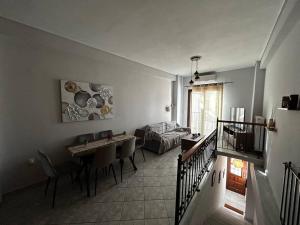 a living room with a table and a couch at Pyrgi Village apartment in Pyrgi