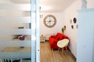 a living room with a red couch and a table at Gong Apartments in Sibiu