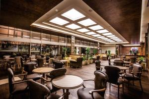 a restaurant with tables and chairs in a room at Gorrion Hotel Istanbul in Istanbul