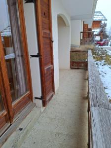 an open door of a house with a porch at Appartement dans un chalet, résidence avec piscine in La Toussuire