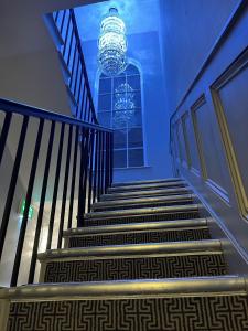 a staircase in a building with a chandelier at Philharmonic Hotel in Liverpool